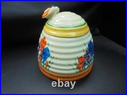 A Clarice Cliff bee hive honey pot in AUTUMN CROCUS pattern